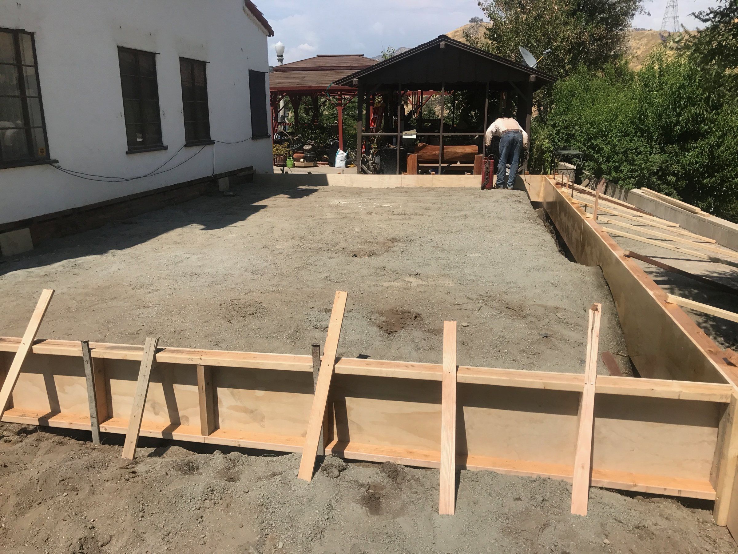 Wood forms staked out for a backyard slab before the pour
